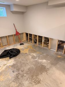 Flooded basement with the bottom of the drywall cut out so the walls can dry